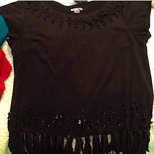 Black shirt, with hole-designs in the neck and below the belly button.